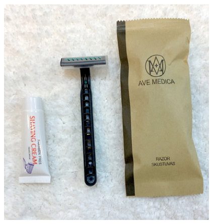 Hotel toothbrush in paper sleeve